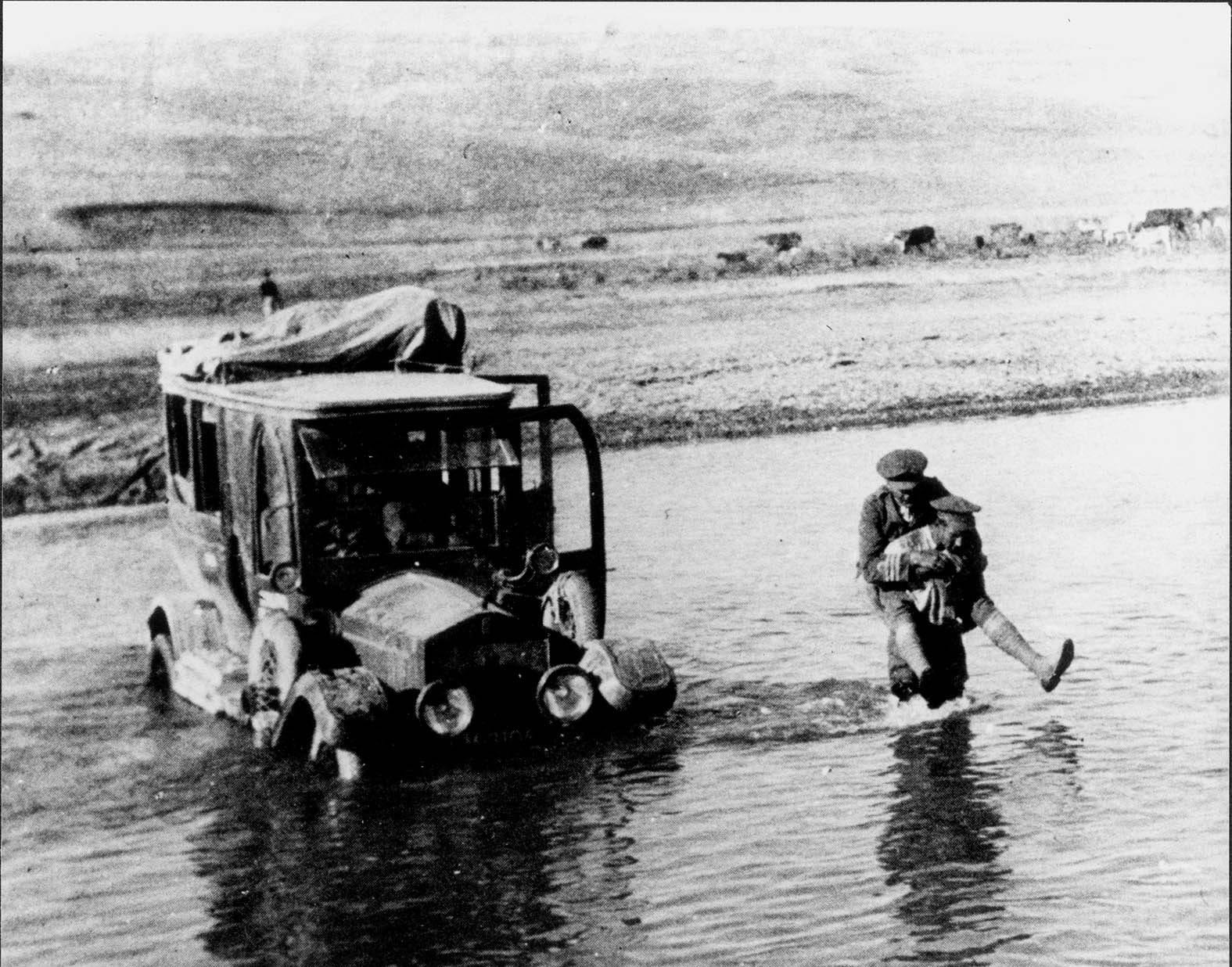 CDR Locker Lampson being carried across a rive