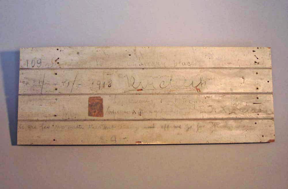 Section of Count Felix von Luckner’s wooden cell from his internment on Ripapa Island, Lyttleton Harbour. The writing reads “109 weary days in this dreary place…we are fed up with this…and off we go…”