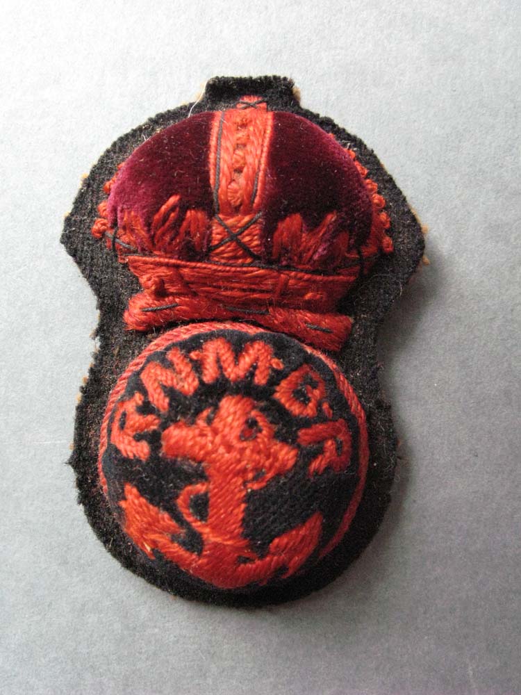 Motor Mechanic cap badge with initials of the Royal Marine Motor Boat Reserve. Worn by Chief Motor Mechanic Len Grigg, WWI