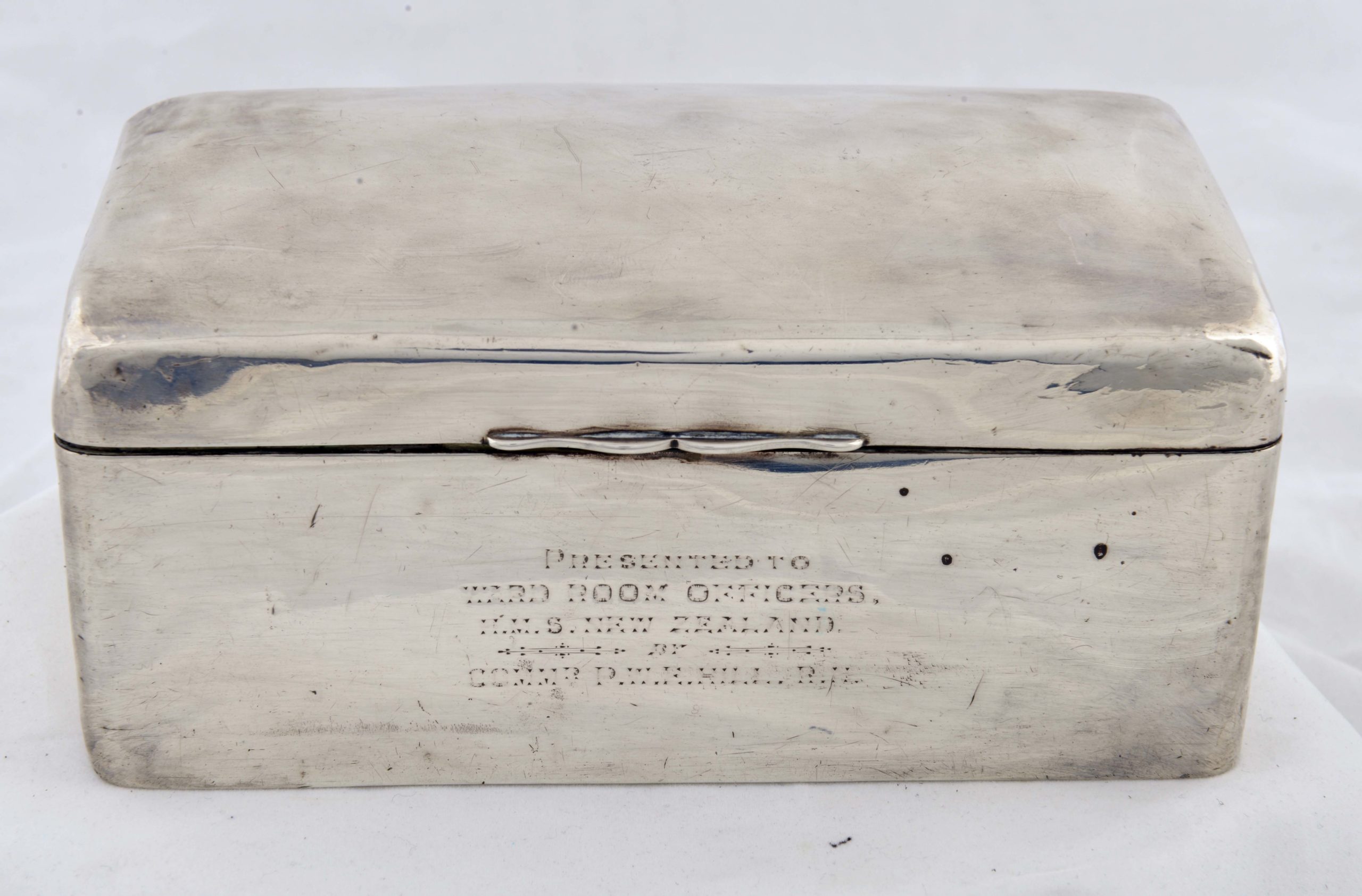 Silver box with wooden inside and a hinged lid presented to HMS New Zealand.