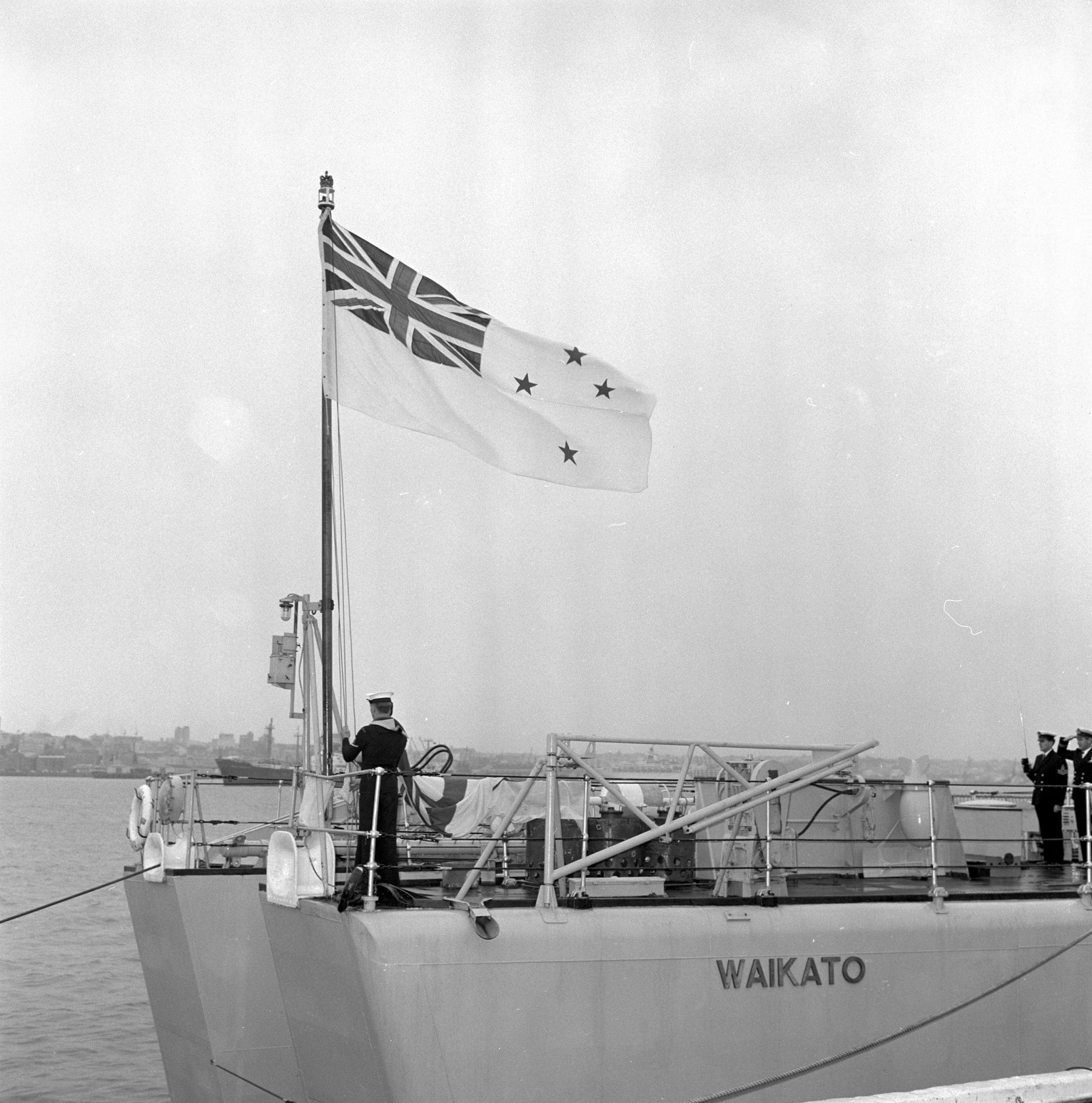 HMNZS Waikato raising the White Ensign