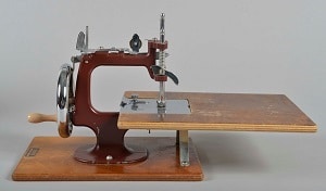 Essex miniature sewing machine, displayed with flatbed attachment.